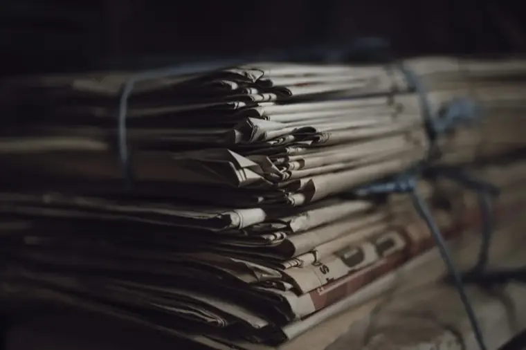A bundle of documents tied closed with string